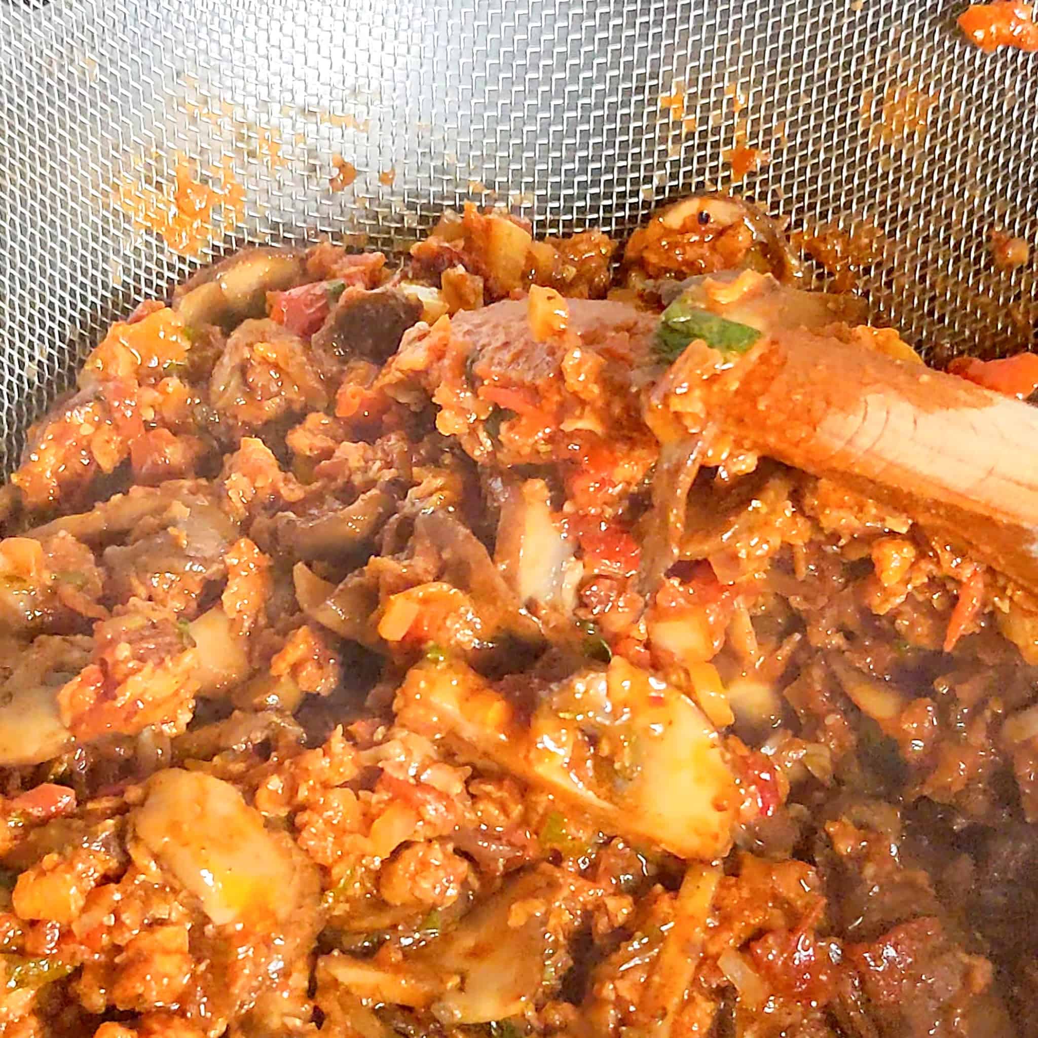 mushroom soy chorizo Vegetarian Birria filling in a strainer.